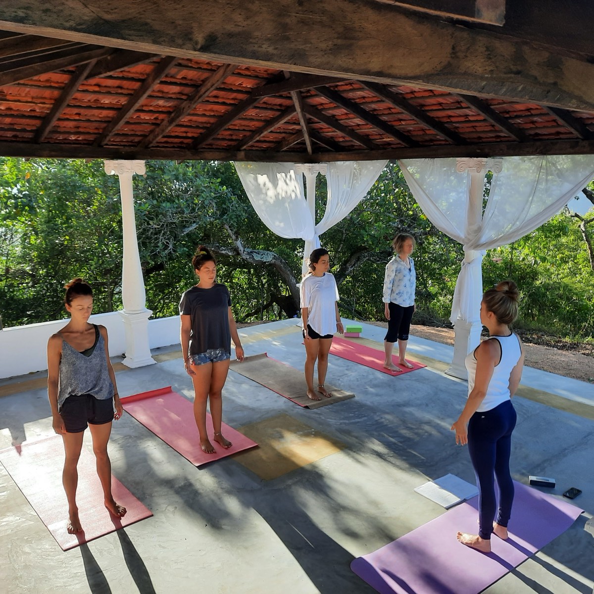 A morning class in the Yin Shala, between its white columns