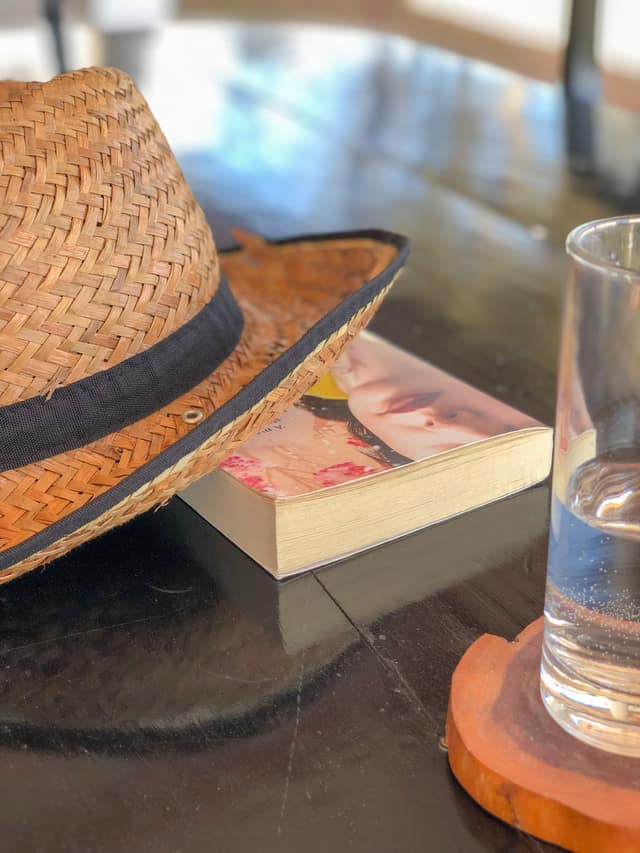 A hat, a book and a glass of water left on the table between sessions