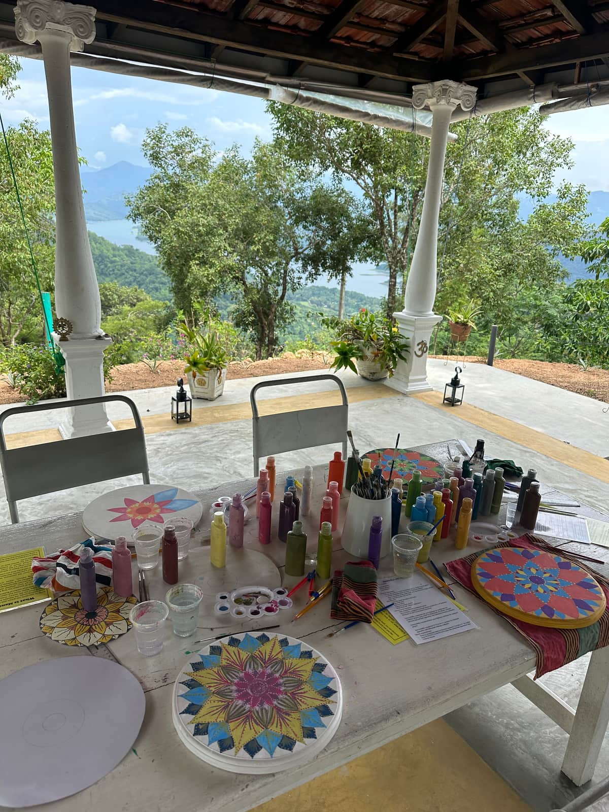 The art room table, with paints and finished mandalas