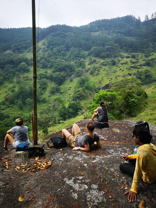 A group resting on the rocks above the valley