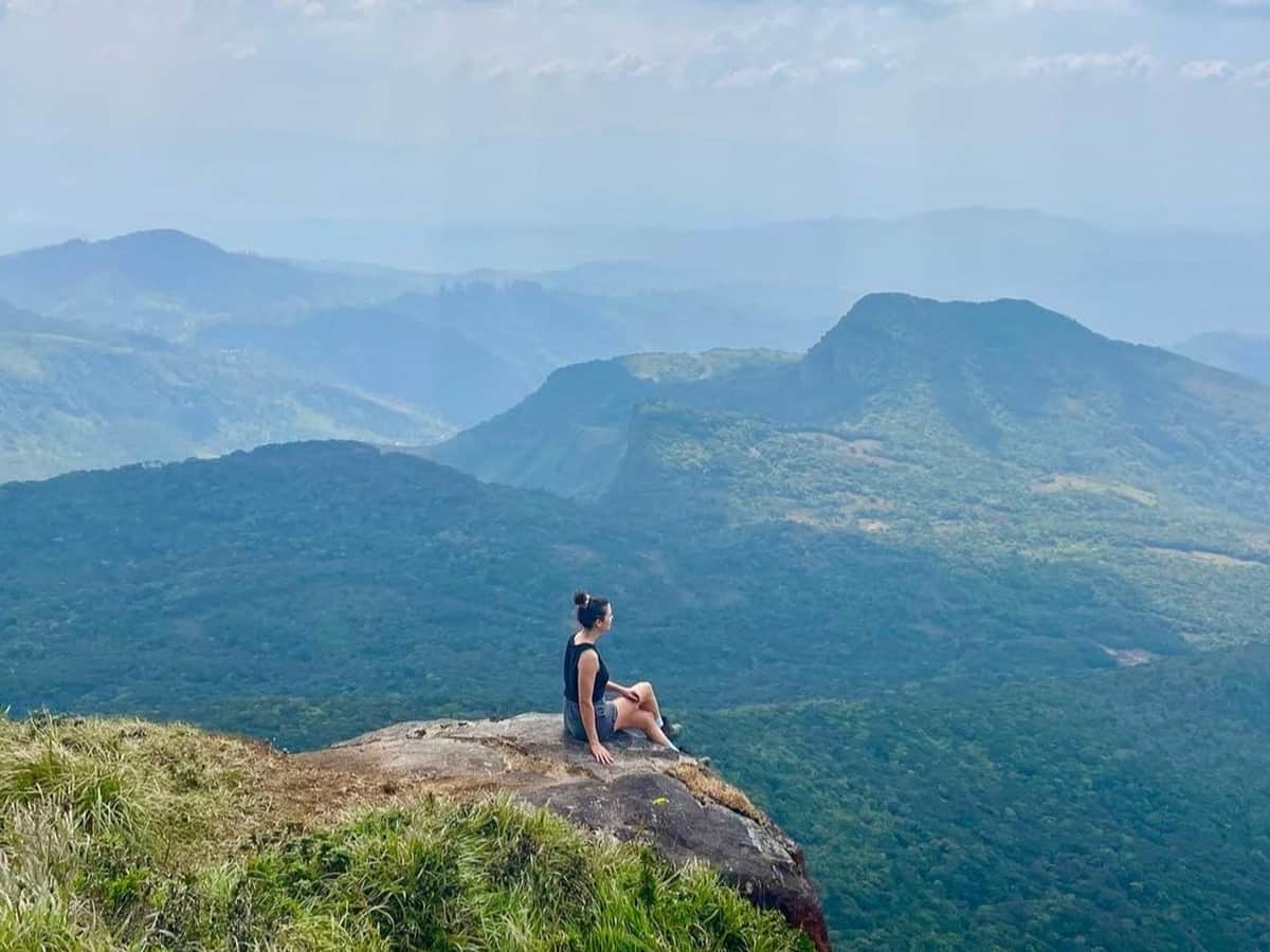 A walker standing on a rock above the Knuckles range