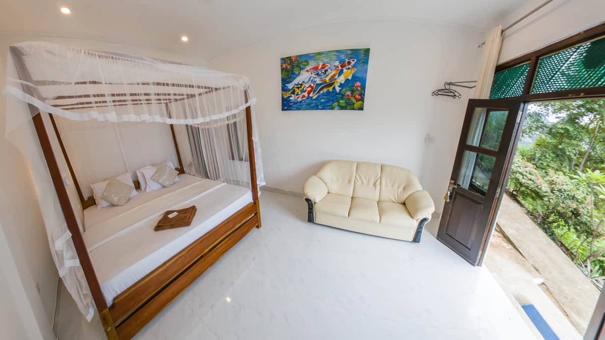 The Victoria Folly room, with a four-poster bed and a seating area