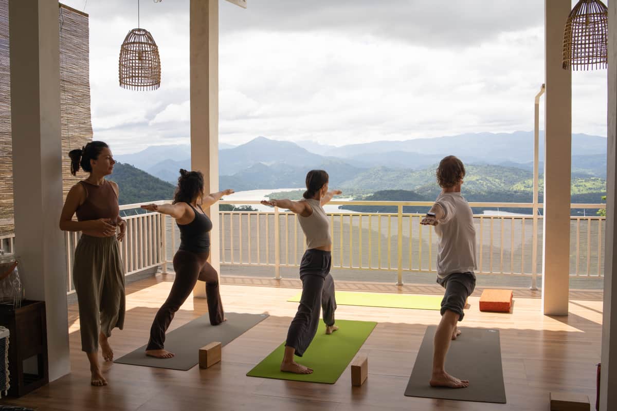 A class practising on the terrace shala, facing the mountains