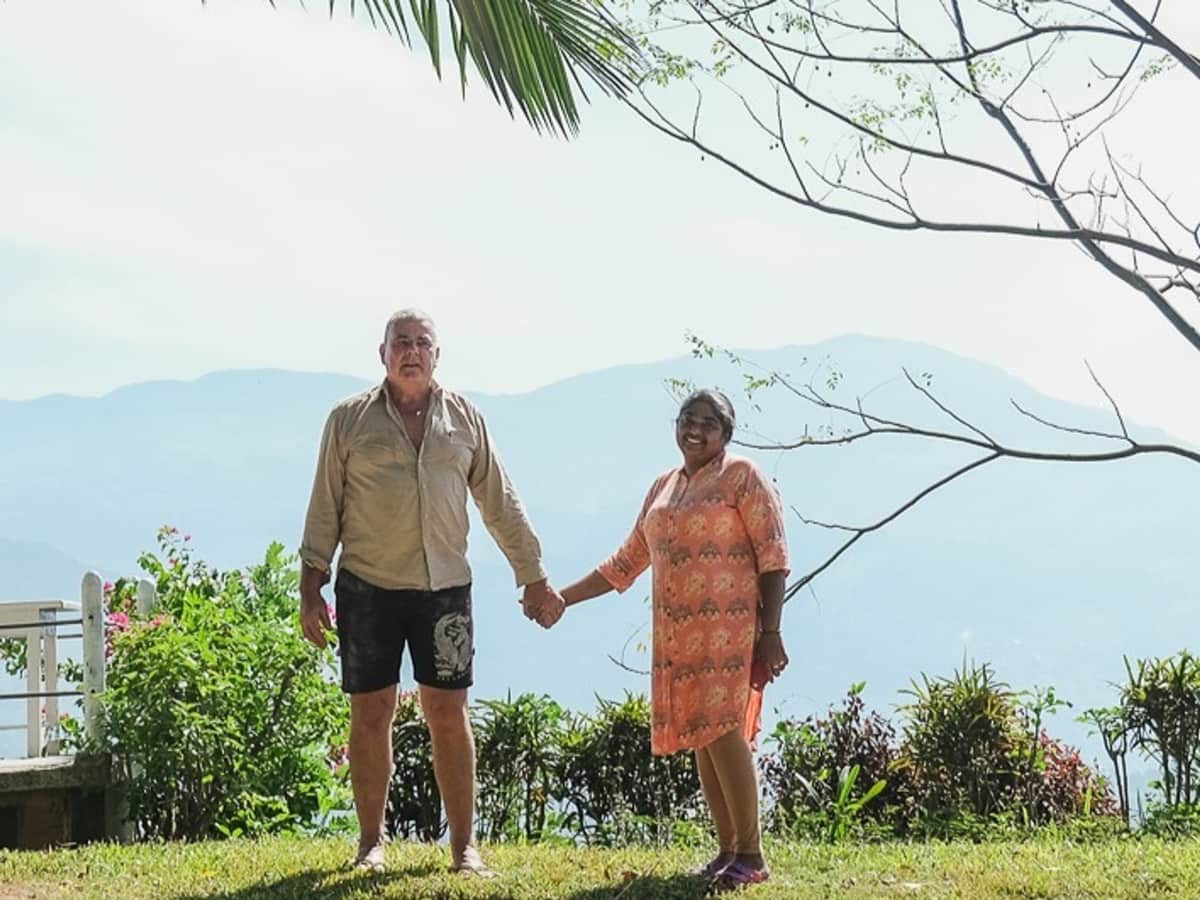Michael and Tush together on the estate, the mountains behind them