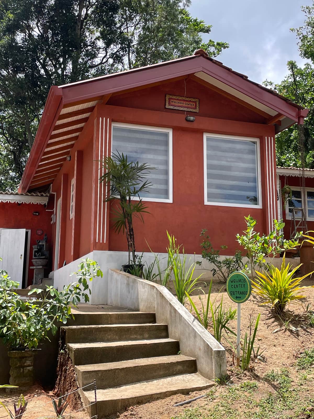 The wellness centre at Welikande, a red building in the garden