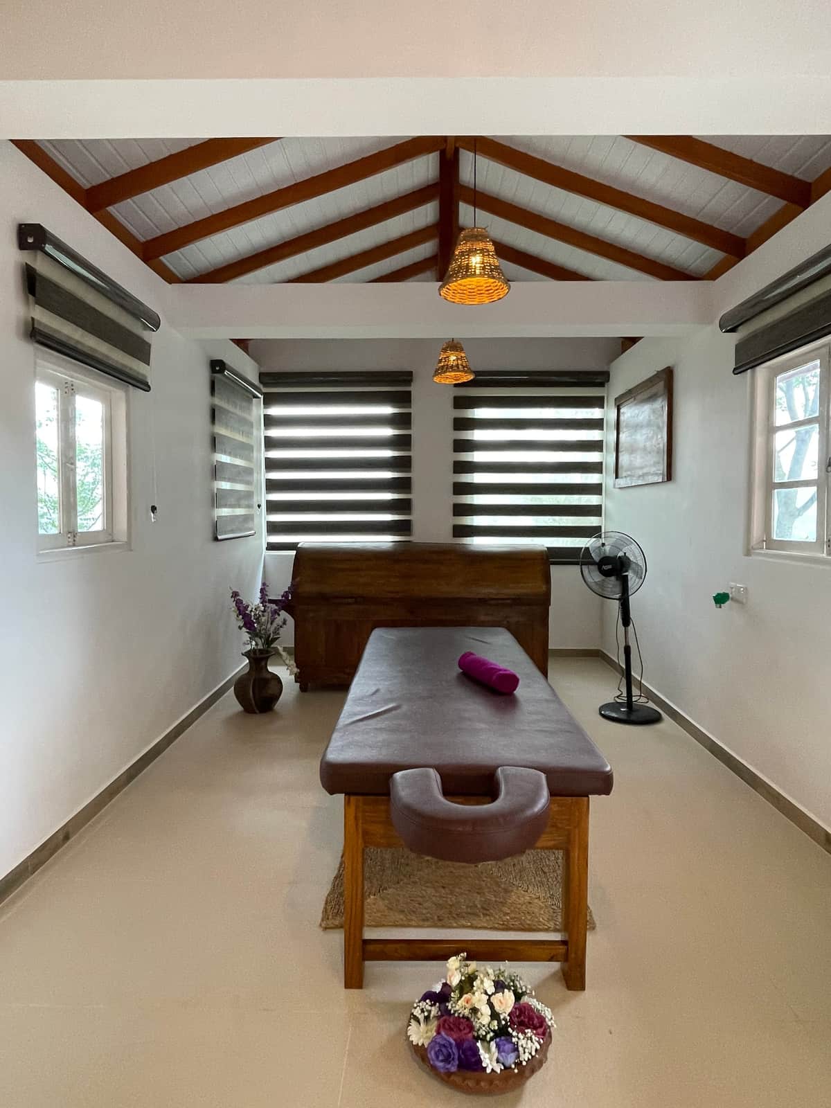 The treatment room in the wellness centre, with its massage table and wooden shutters