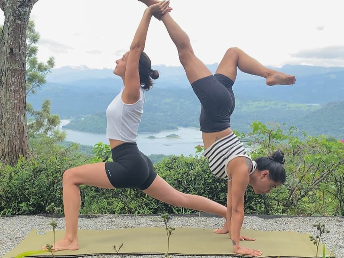 Partner yoga on the terrace above Victoria Lake